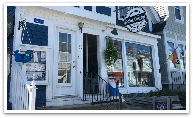 a blue and white building with windows and a sign reading "Going Coastal established 2022. Chester, NS".