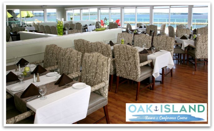 Oak and Ore dining room. Tables have white table cloths, padded chairs, panoramic views of the ocean.